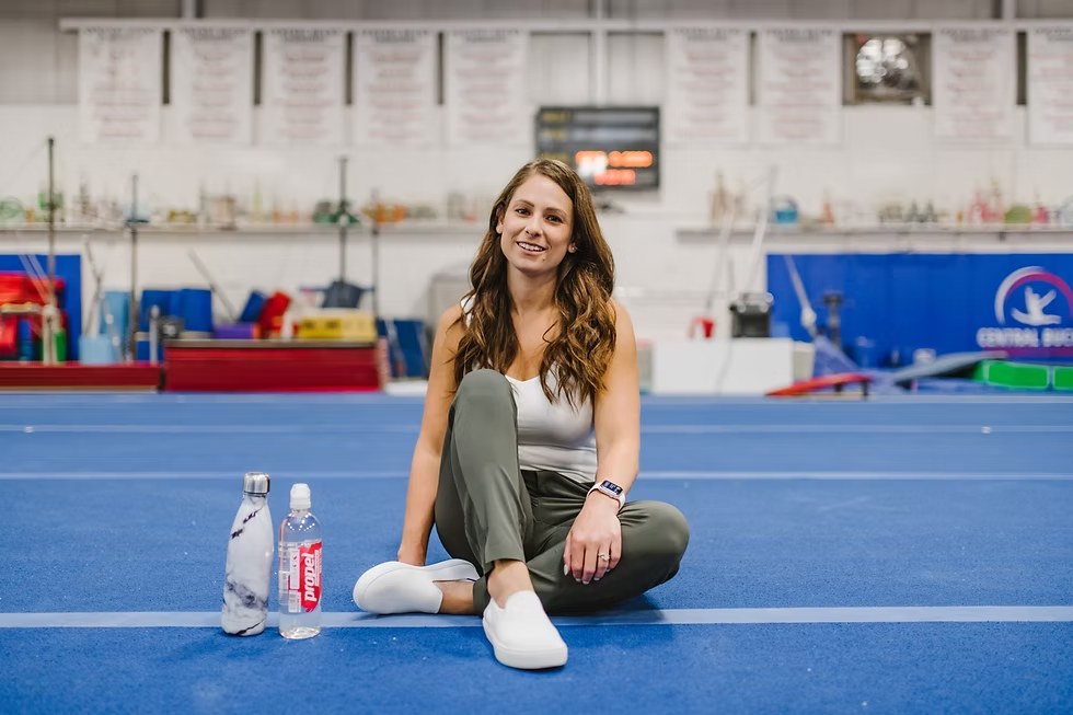 Kerry Bair, sports dietitian, on the gym floor with a water bottle